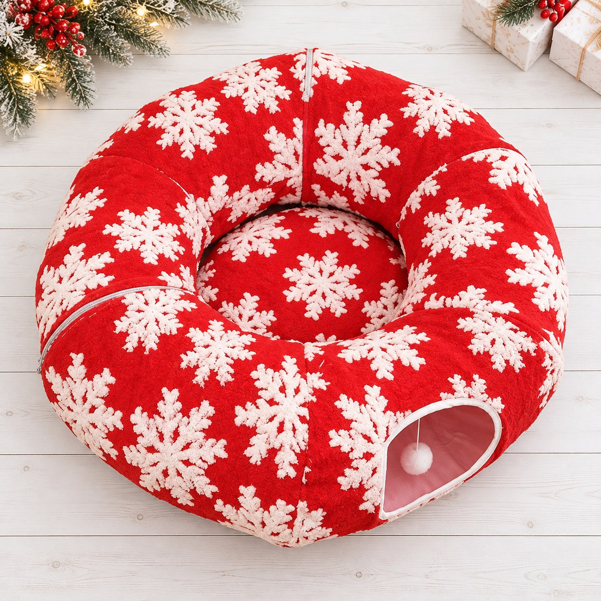 Red donut cat bed with a round center cushion and white snowflake pattern